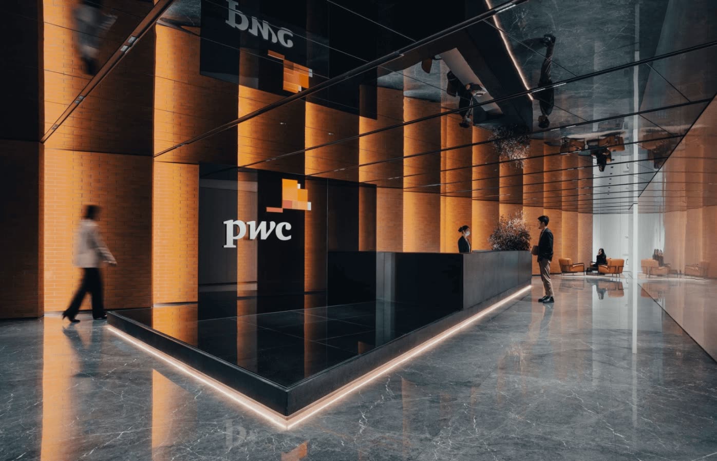 PwC Shanghai lobby with warm amber lighting and marble floors